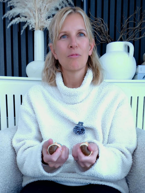 Nanette holding two Oceanbum tactile companions during a PuffZenDen breathing exercise.